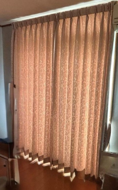 掃き出し窓に新しいカーテンを取り付け、明るくなった室内