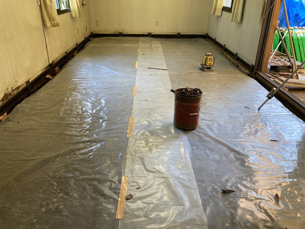 床下に防湿シートを敷き、湿気対策を行っている様子