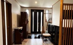 新しい玄関床と照明が、以前から使われていた家具と調和しているリノベーション事例。